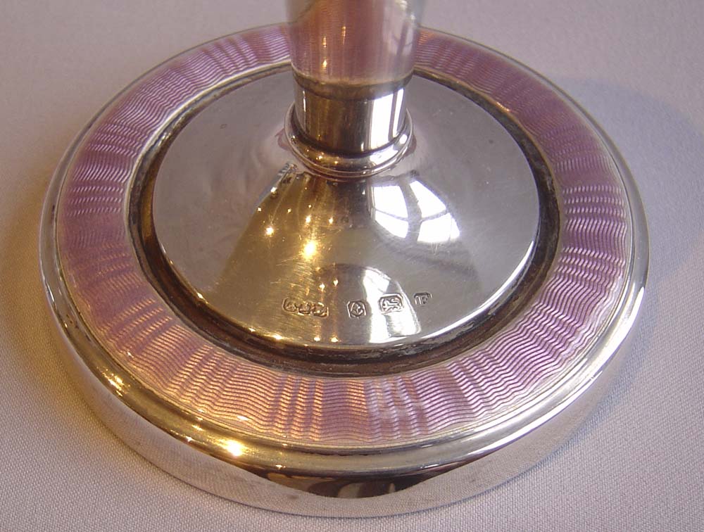 Silver and lilac guilloche enamel garniture of clock and pair of candlesticks..