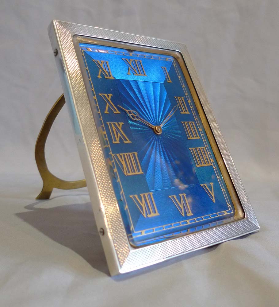 Strut clock in silver and petrol blue guilloche enamel.
