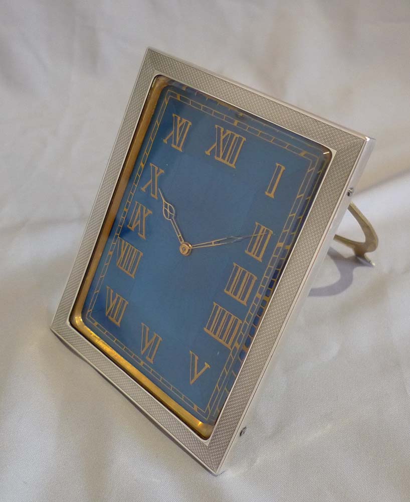 Strut clock in silver and petrol blue guilloche enamel.