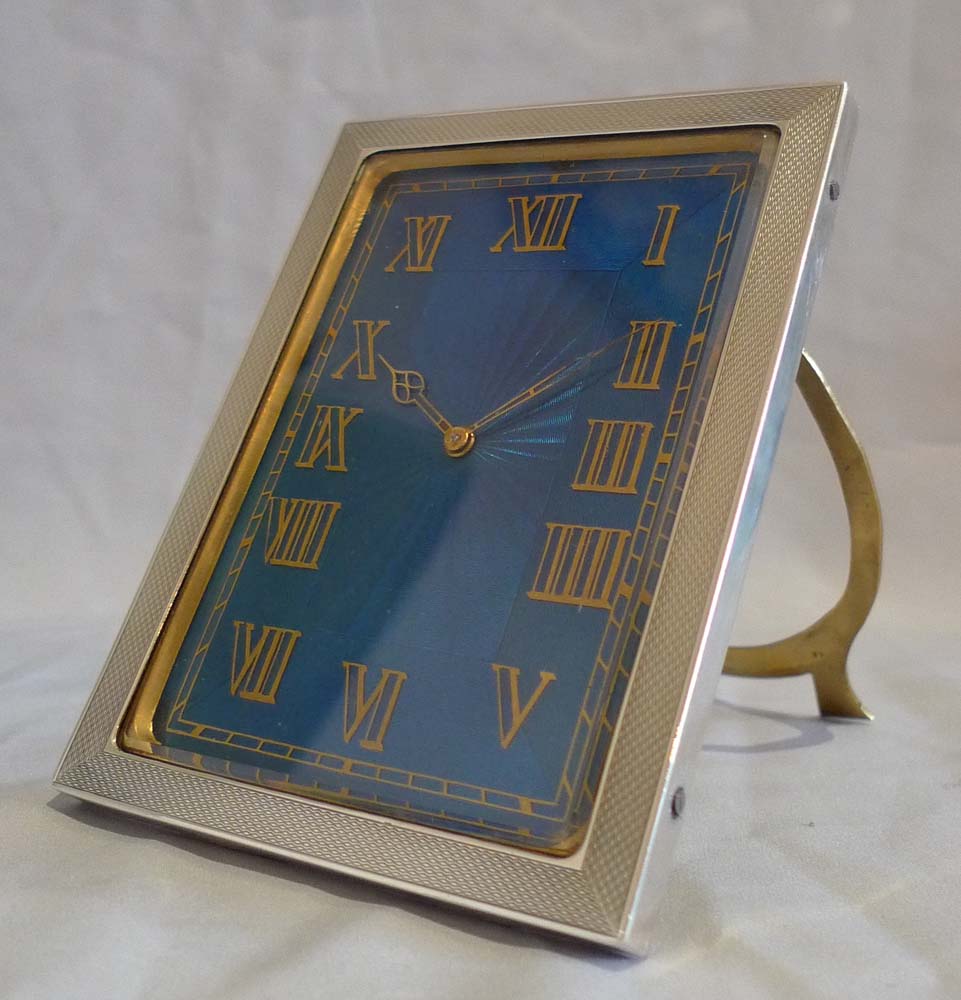 Strut clock in silver and petrol blue guilloche enamel.