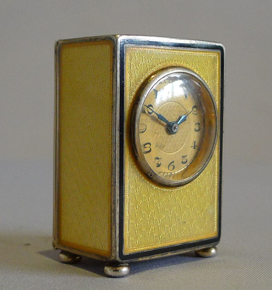 Sub miniature carriage clock in lemon yellow guilloche enamel and silver gilt.