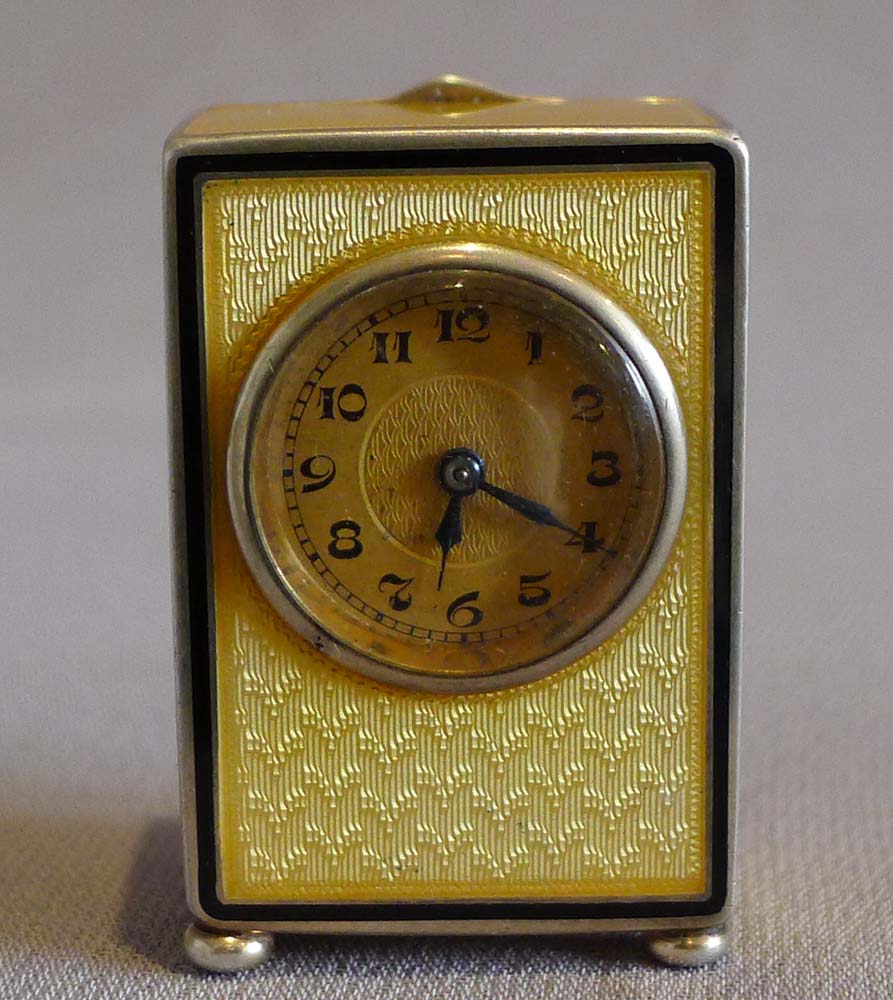 Sub miniature carriage clock in lemon yellow guilloche enamel and silver gilt.