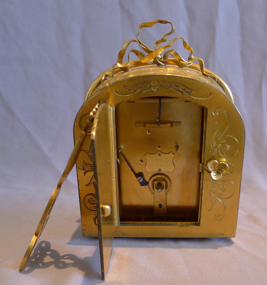 English ormolu mantel clock in manner of Cole by Barry of London with signed carved limewood dial.