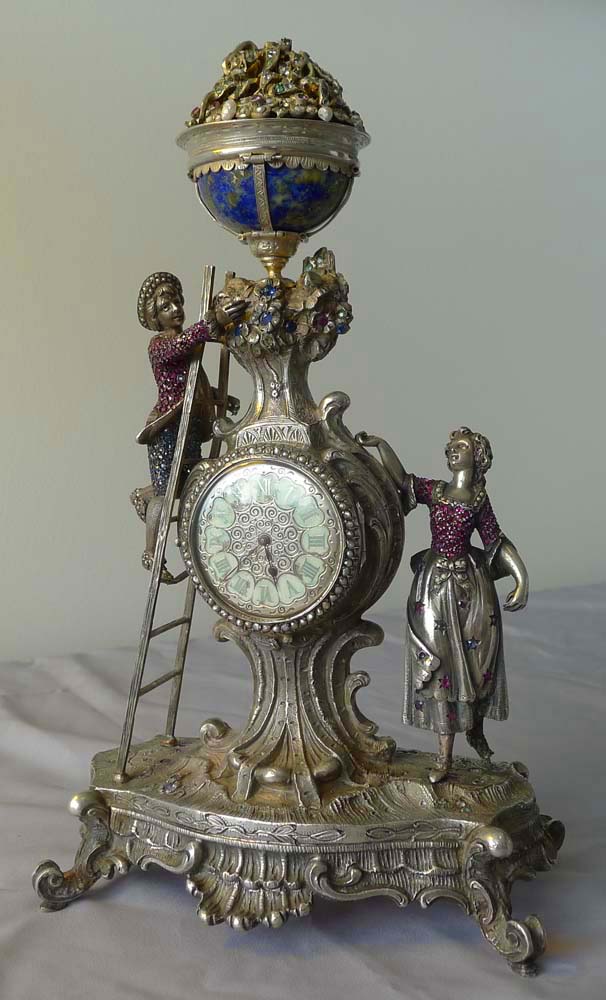 Spectacular antique Viennese silver and jewelled clock of young couple picking fruit from a tree.