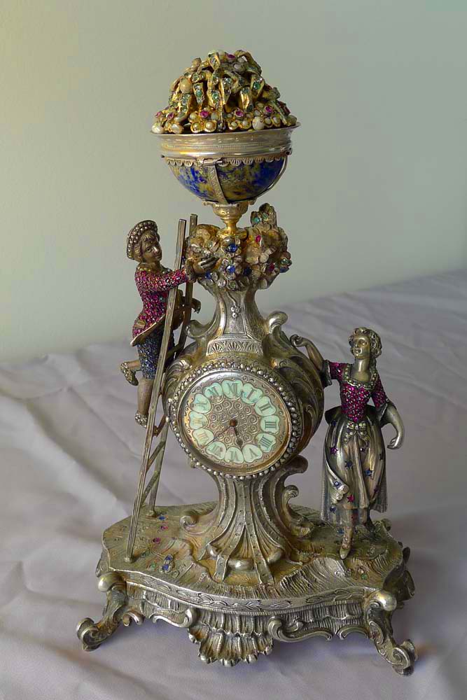 Spectacular antique Viennese silver and jewelled clock of young couple picking fruit from a tree.