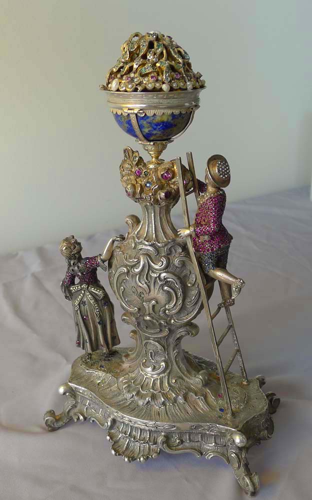 Spectacular antique Viennese silver and jewelled clock of young couple picking fruit from a tree.