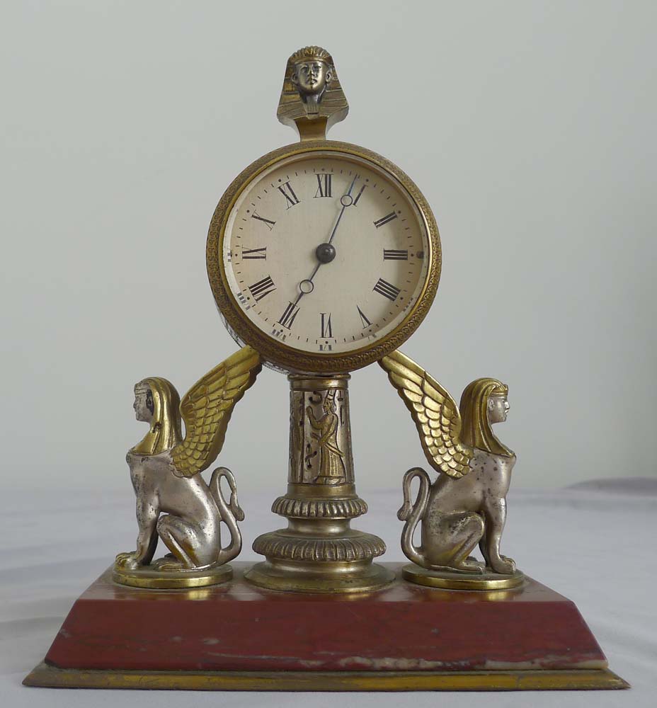 Fine and unusual desk timepiece of Retour d'Egypt or Egyptian Revival in gilt and silvered bronze.