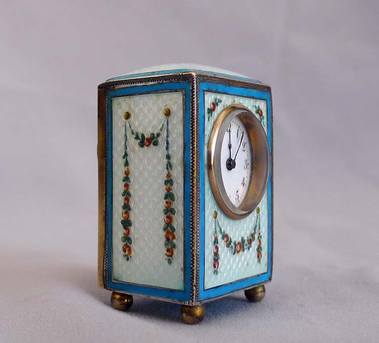 Sub-miniature carriage clock with hand painted guilloche enamel.