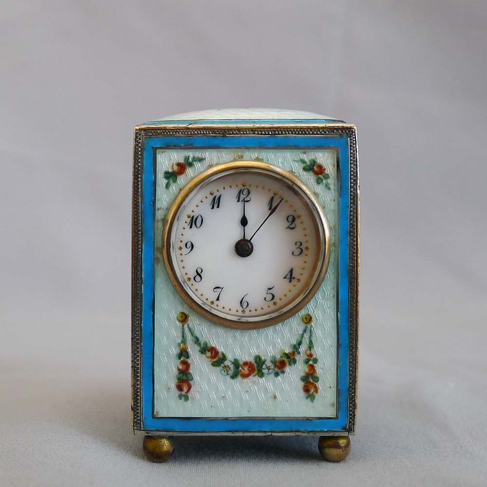 Sub-miniature carriage clock with hand painted guilloche enamel.