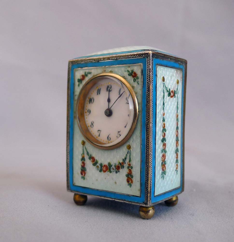 Sub-miniature carriage clock with hand painted guilloche enamel.