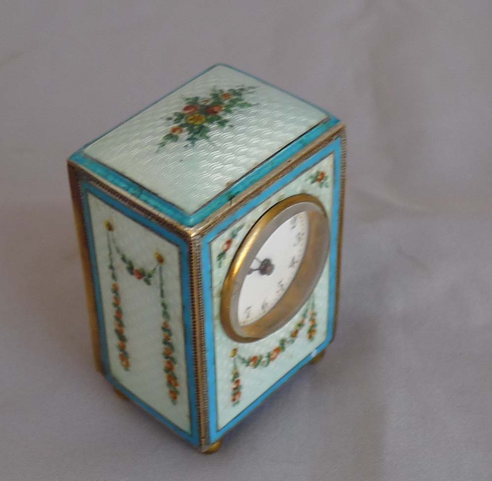 Sub-miniature carriage clock with hand painted guilloche enamel.