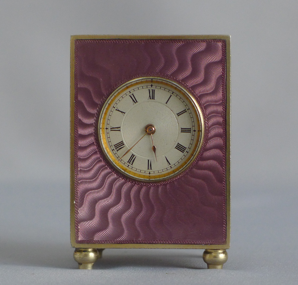 Fine silver gilt, and pink guilloche enamel sub minature carriage or boudoir clock in original case