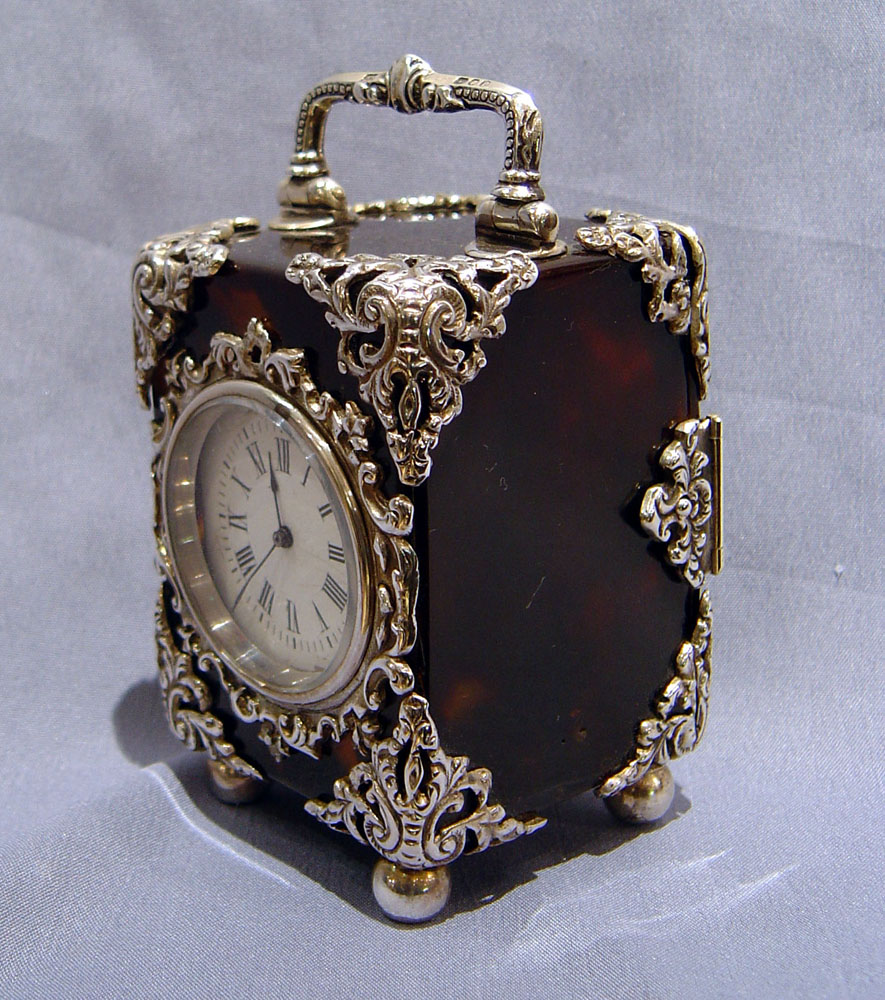 Antique English silver mounted tortoiseshell carriage clock.