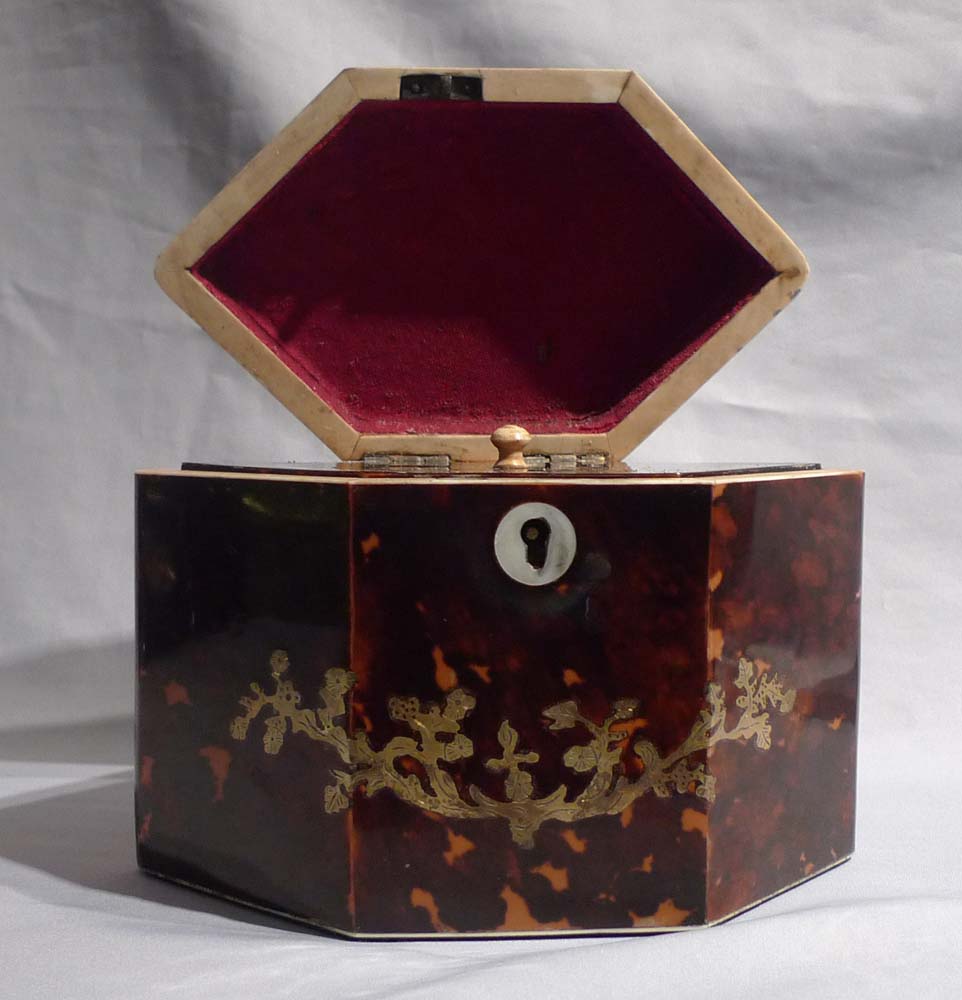 Antique tortoiseshell and brass inlaid tea caddy.