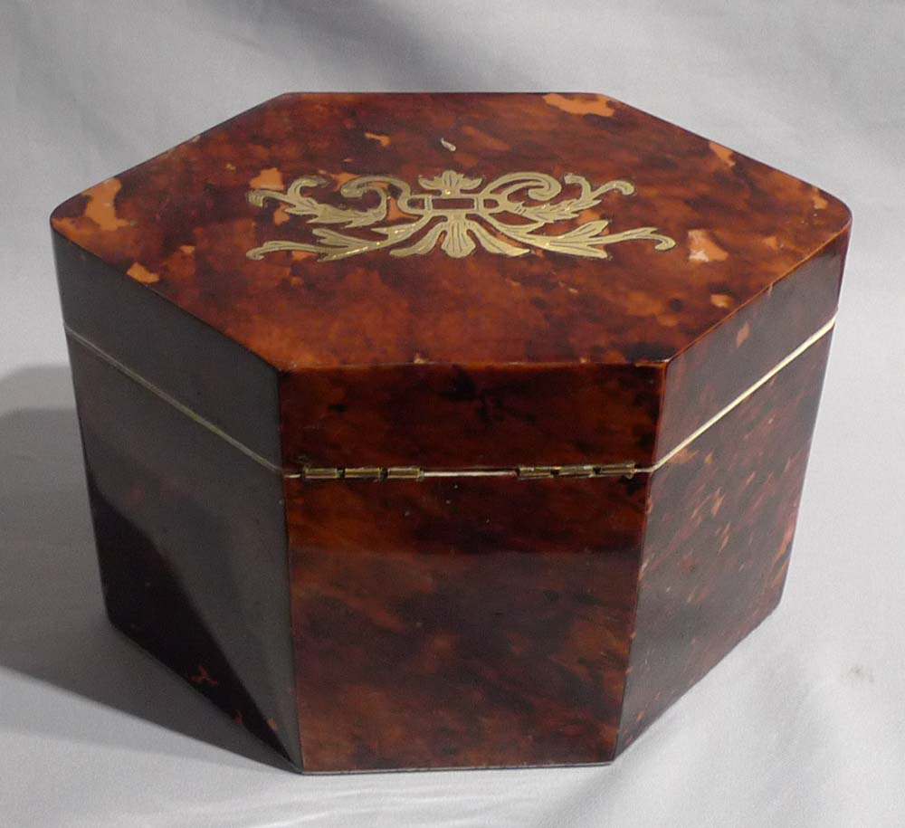 Antique tortoiseshell and brass inlaid tea caddy.