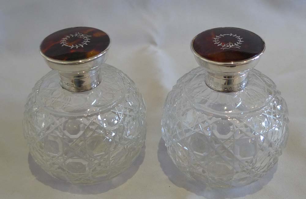 Pair tortoiseshell pique silver and cut glass spherical perfume bottles.