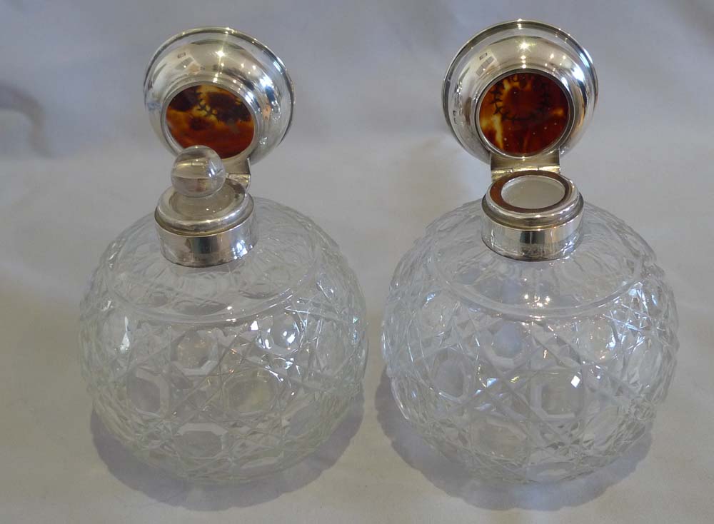 Pair tortoiseshell pique silver and cut glass spherical perfume bottles.