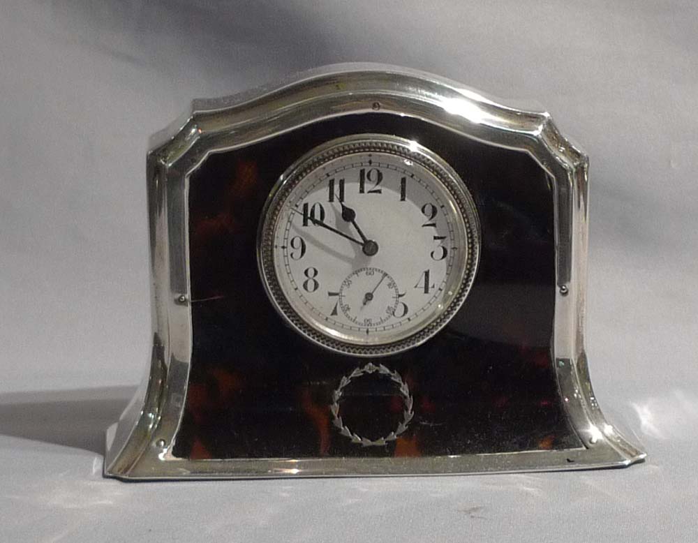 Silver and tortoiseshell pique mantel clock.