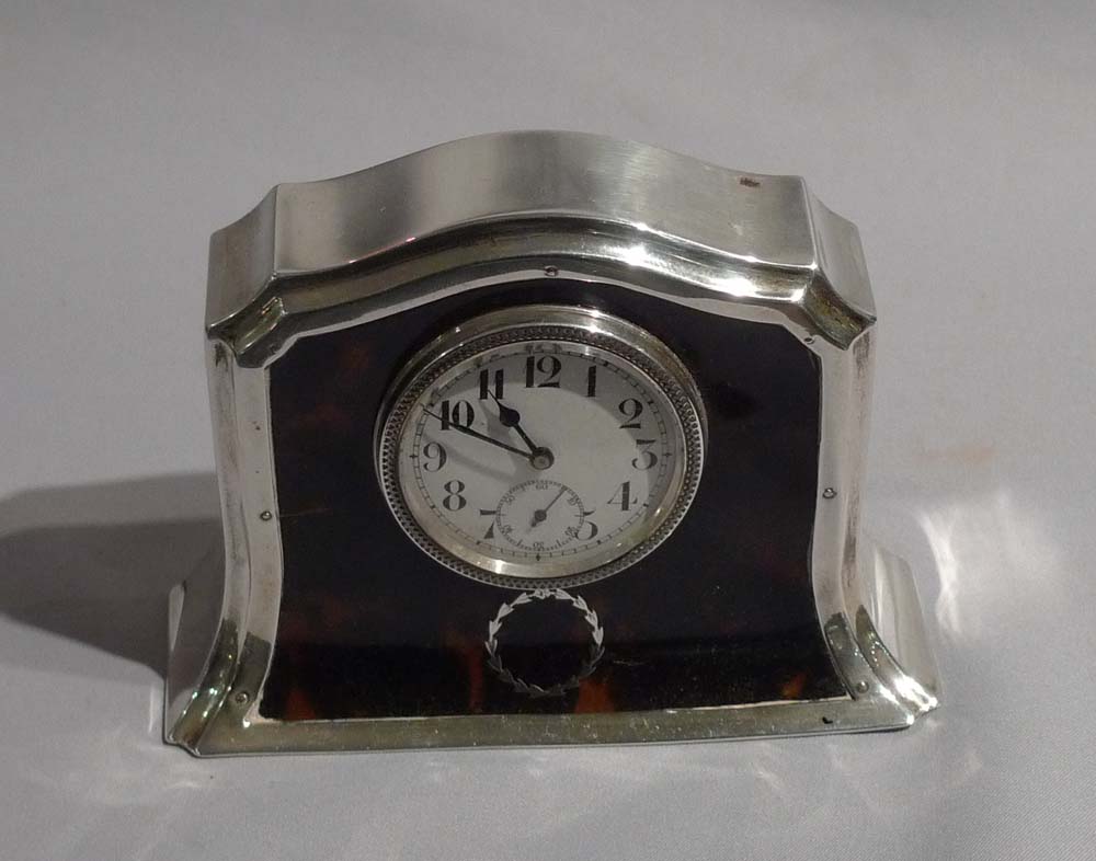 Silver and tortoiseshell pique mantel clock.