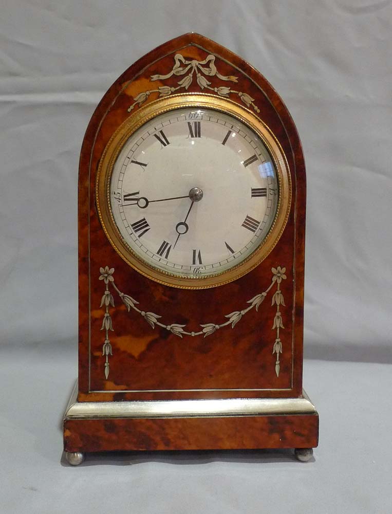 Fine antique tortoiseshell and silver inlaid lancet shaped mantel clock.