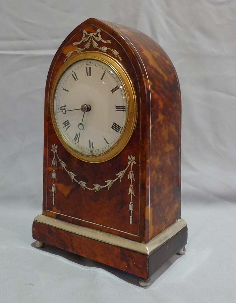 Fine antique tortoiseshell and silver inlaid lancet shaped mantel clock.