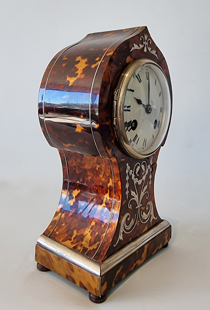 Antique tortoiseshell mantel clock with silver inlay and stringing