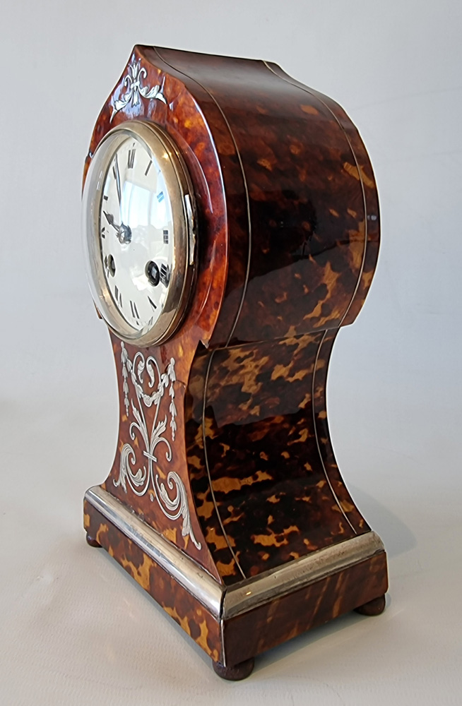 Antique tortoiseshell mantel clock with silver inlay and stringing
