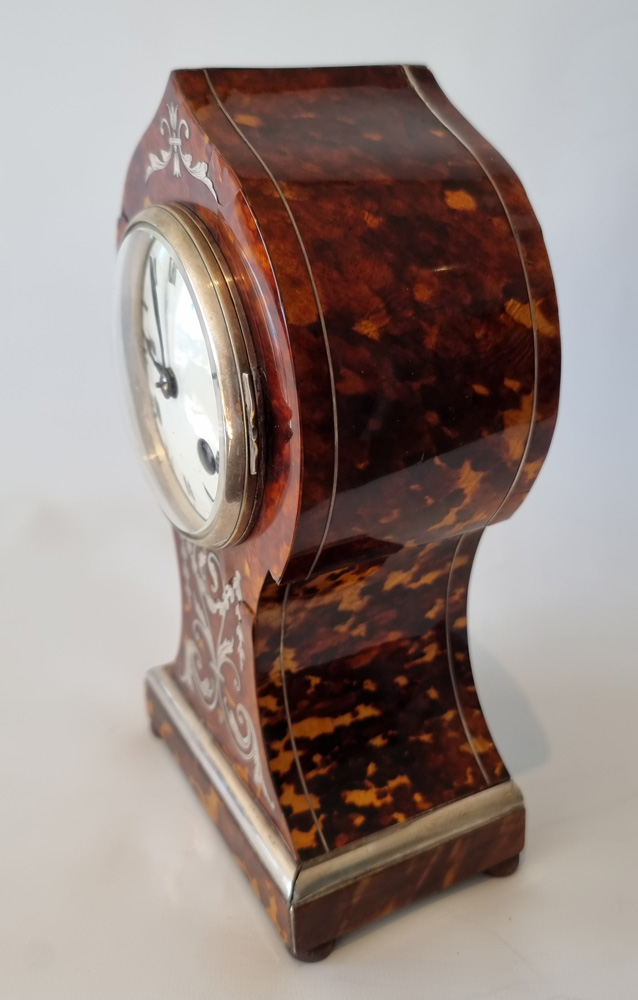 Antique tortoiseshell mantel clock with silver inlay and stringing