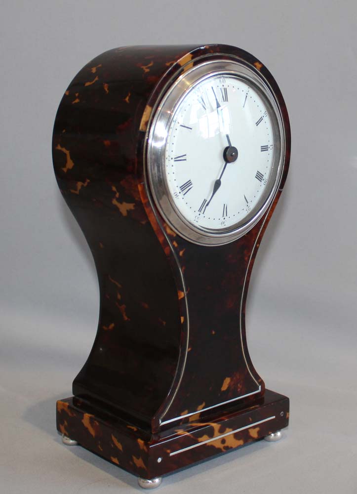 Antique English tortoiseshell and silver strung balloon shaped mantel clock.