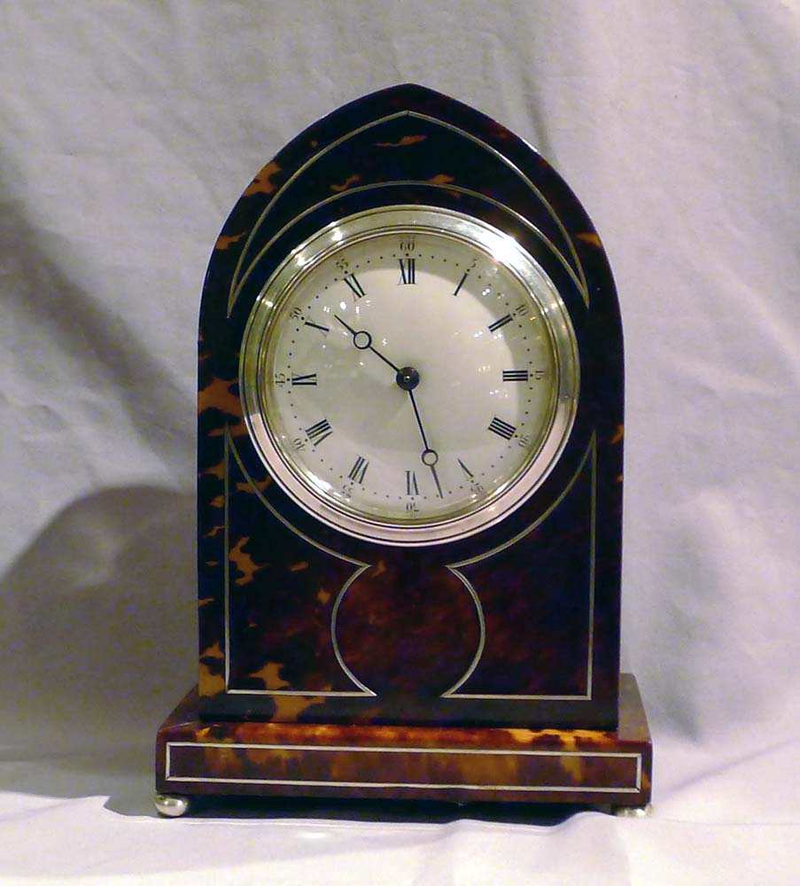 Fine Tortoiseshell mantel clock lancet topped with silver stringing and enamel dial.