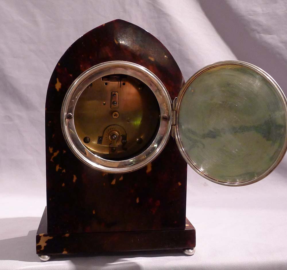 Fine Tortoiseshell mantel clock lancet topped with silver stringing and enamel dial.