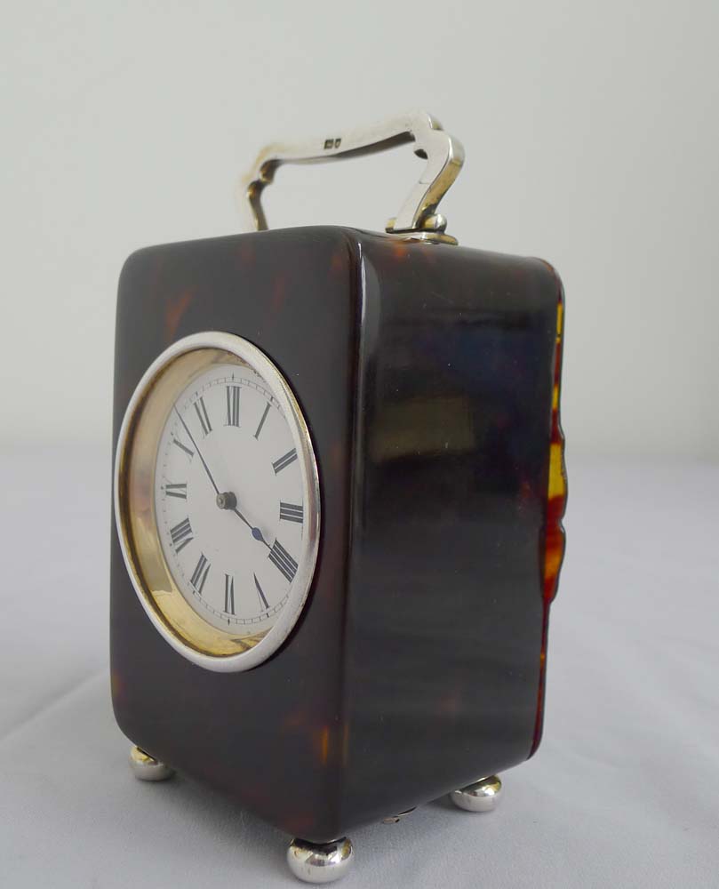 A fine silver mounted tortoiseshell carriage clock.