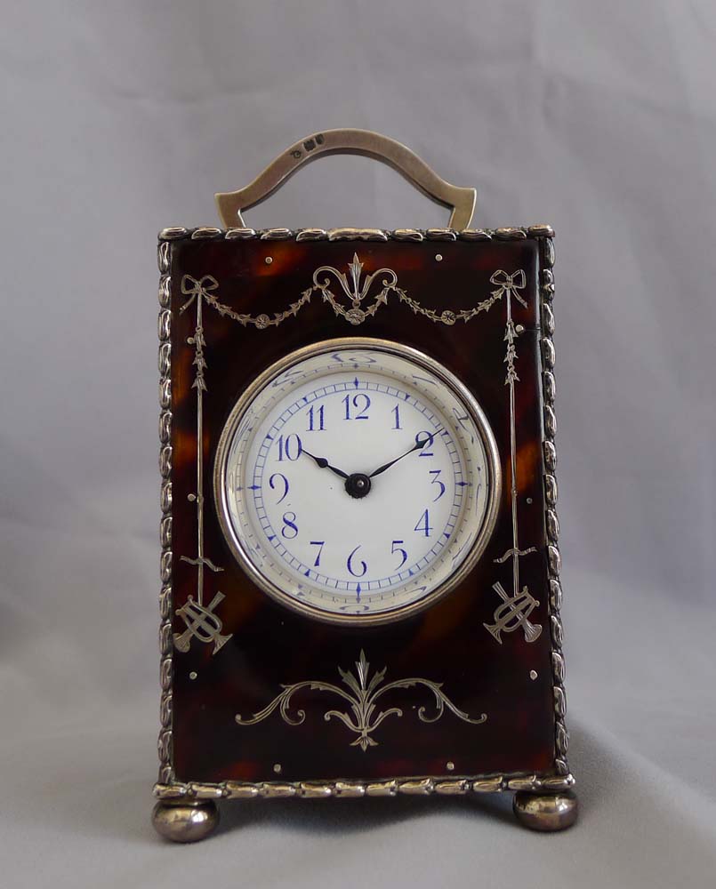 Antique English tortoiseshell and silver piquet carriage clock by William Comyns. London 1905.