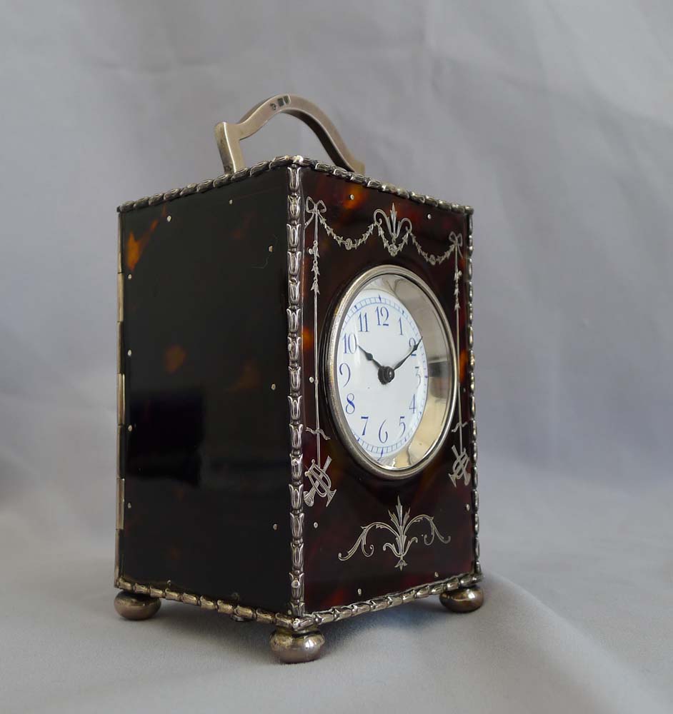 Antique English tortoiseshell and silver piquet carriage clock by William Comyns. London 1905.