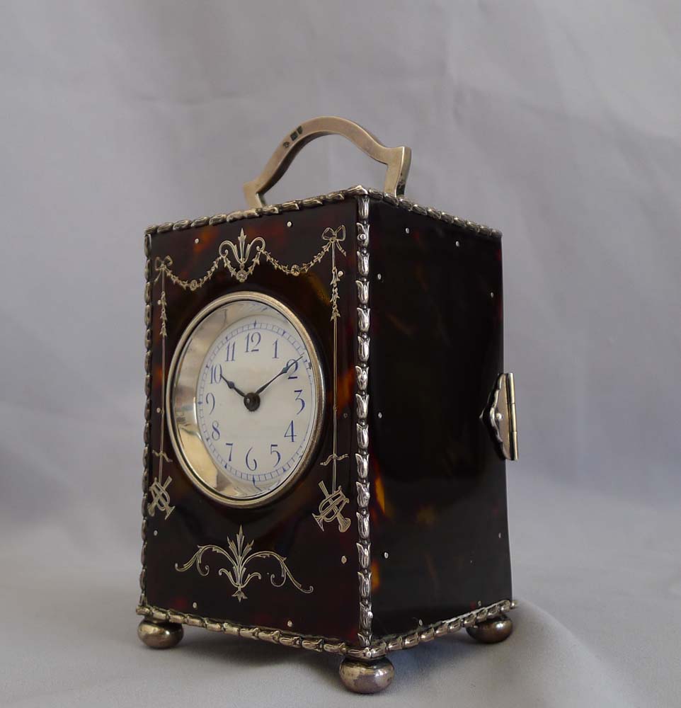Antique English tortoiseshell and silver piquet carriage clock by William Comyns. London 1905.