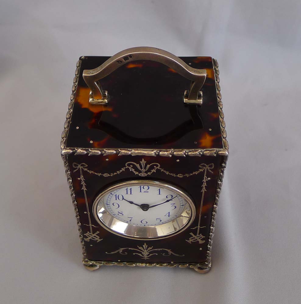 Antique English tortoiseshell and silver piquet carriage clock by William Comyns. London 1905.