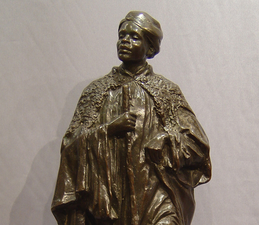 English Bronze figure of a Negro man on shaped base.