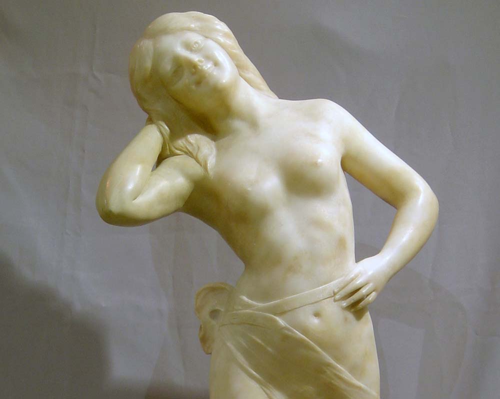 Antique Art Nouveau alabaster sculpture of semi draped woman.