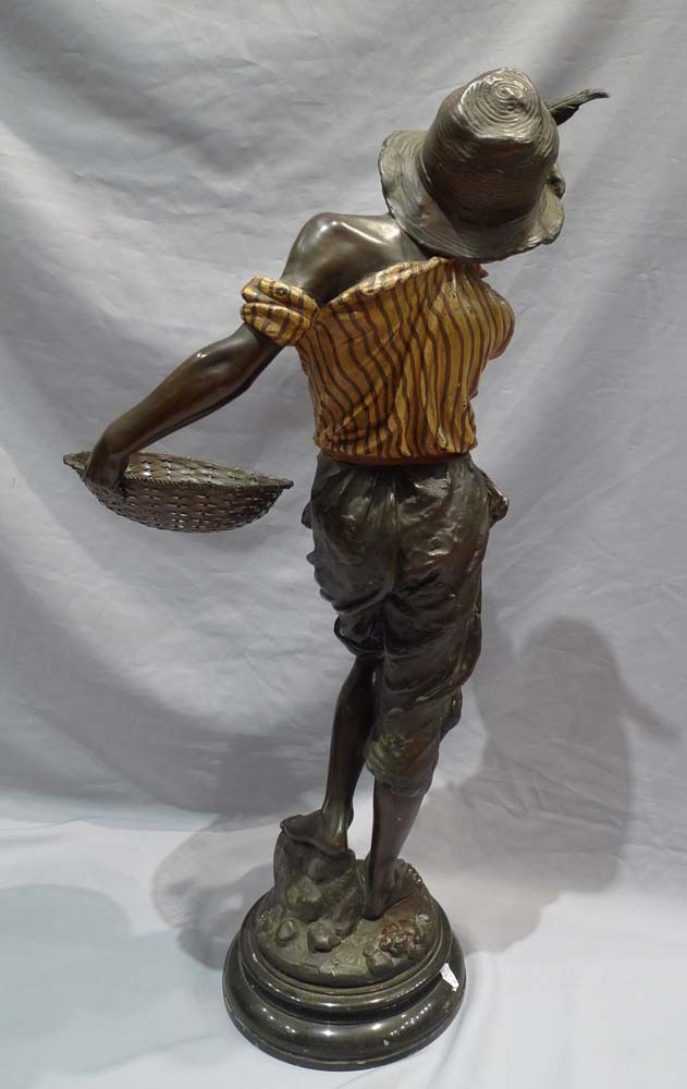 Good sculpture of a black boy smoking a pipe and holding a basket.