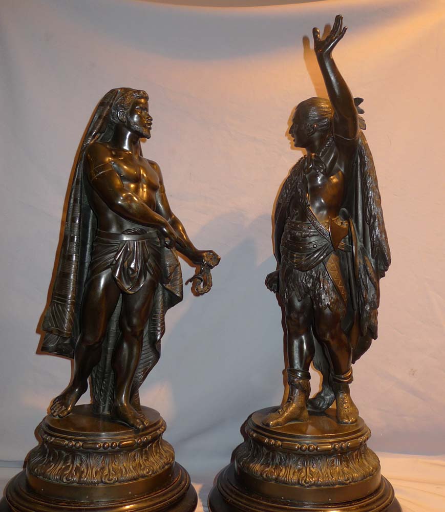 Antique pair of figures depicting America and Africa in bronzed spelter of fine quality.