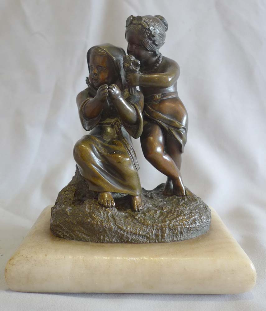 Antique French patinated bronze group of two children on white marble cushion base, mid 19th century