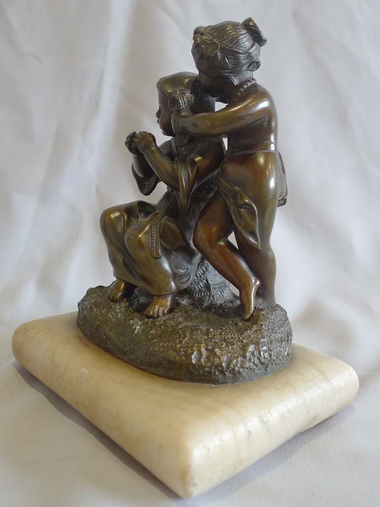 Antique French patinated bronze group of two children on white marble cushion base, mid 19th century