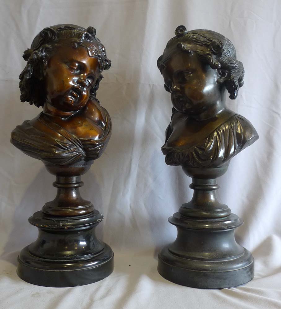 Antique pair of bronze busts of childs' heads on marble bases.