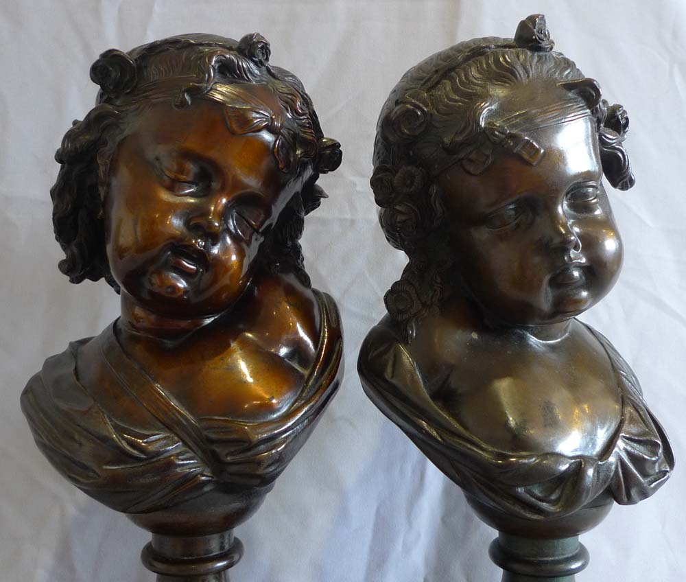 Antique pair of bronze busts of childs' heads on marble bases.