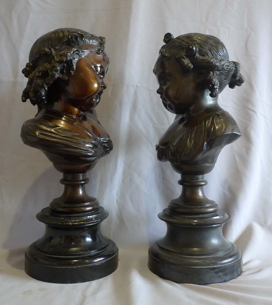 Antique pair of bronze busts of childs' heads on marble bases.