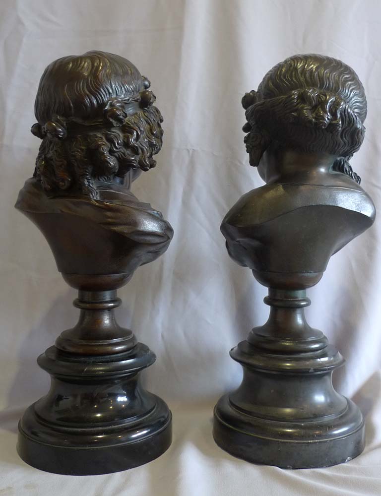 Antique pair of bronze busts of childs' heads on marble bases.