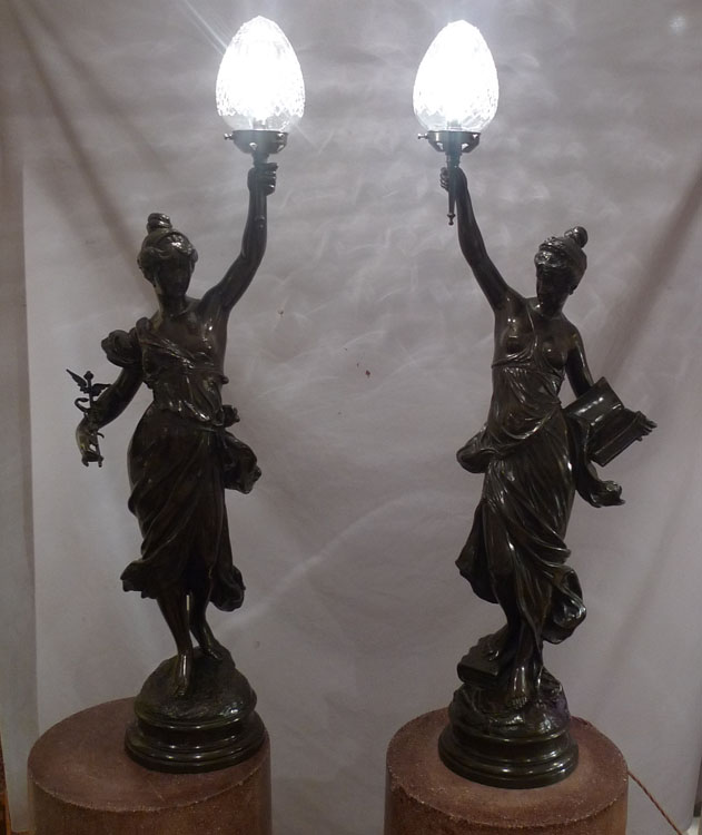 Antique pair of figural bronze lamps of classical semi draped maidens..