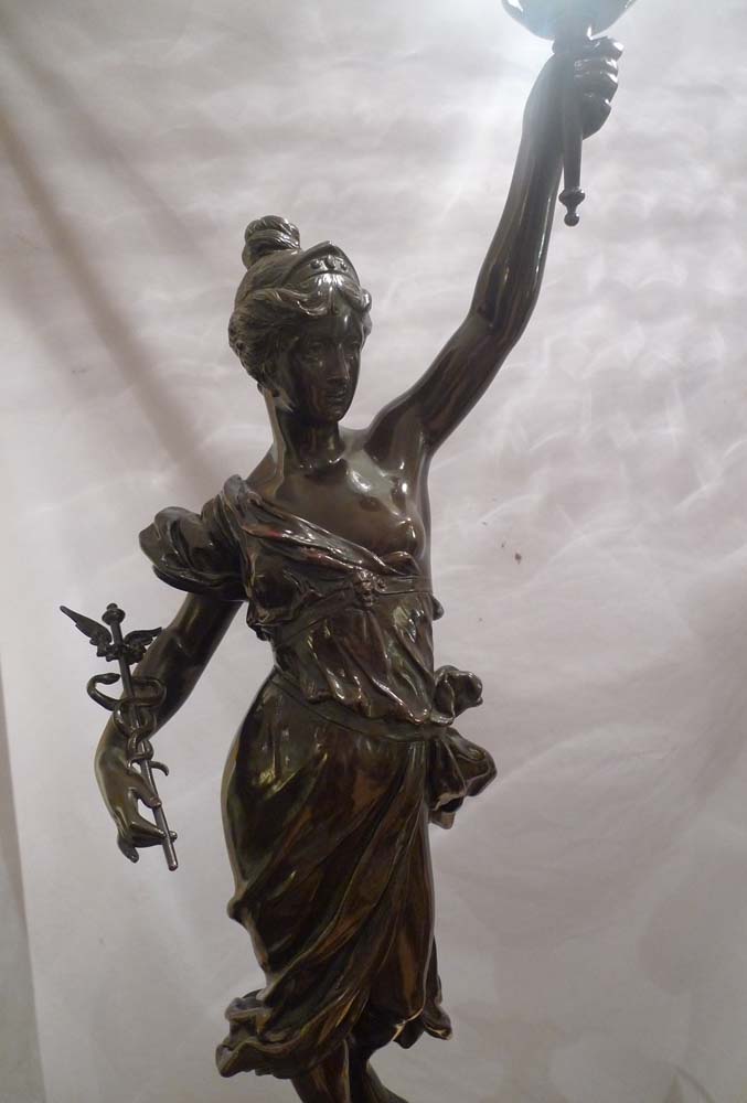 Antique pair of figural bronze lamps of classical semi draped maidens..