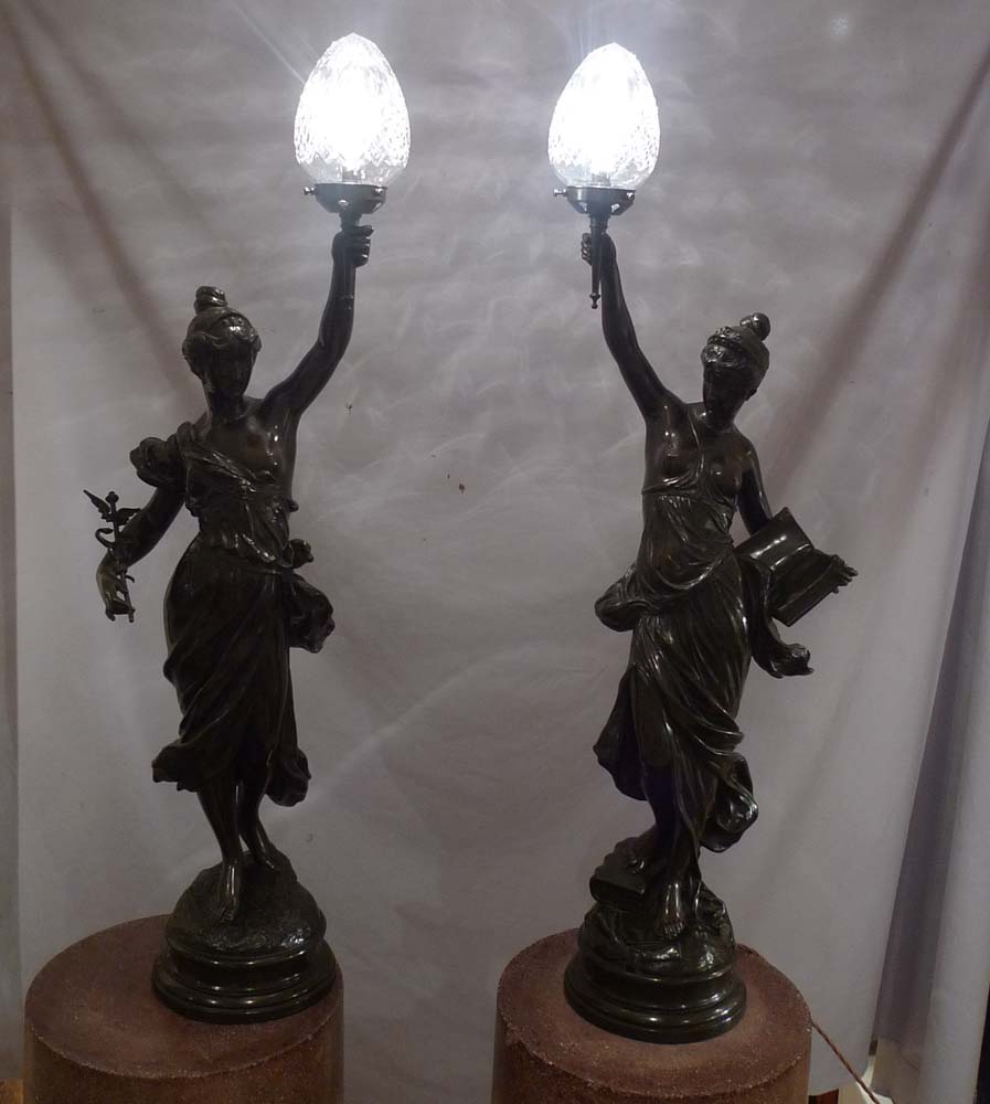 Antique pair of figural bronze lamps of classical semi draped maidens..