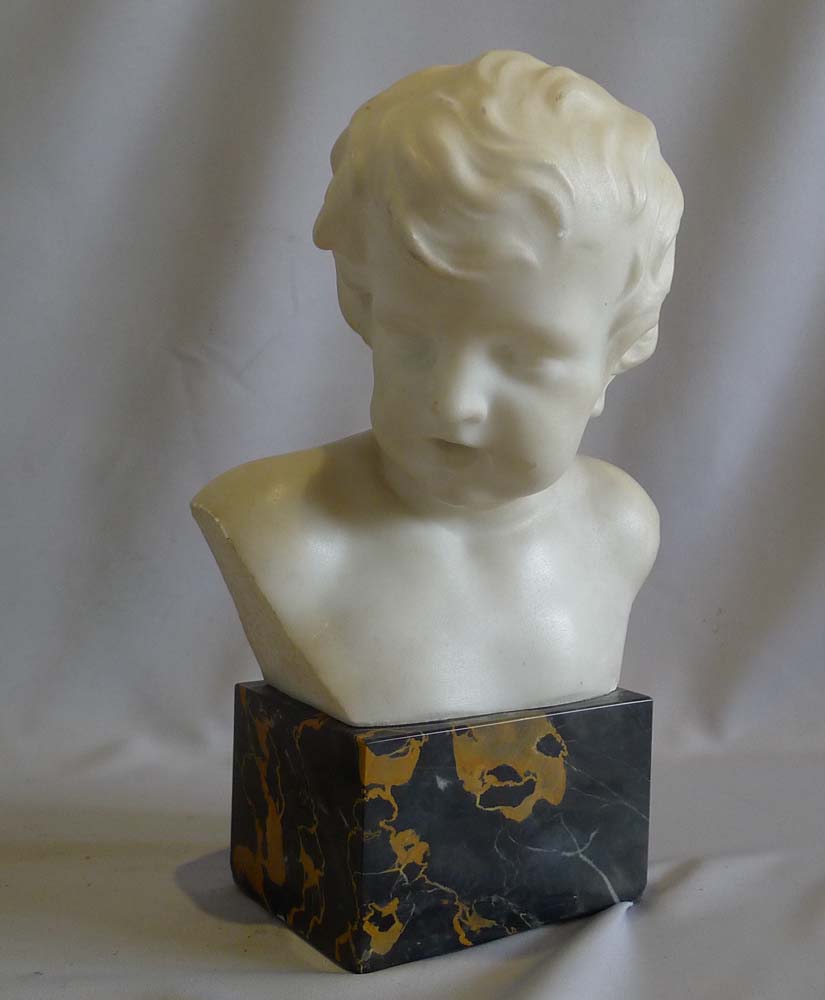 Antique pair of white marble busts of children on variegated marble bases.